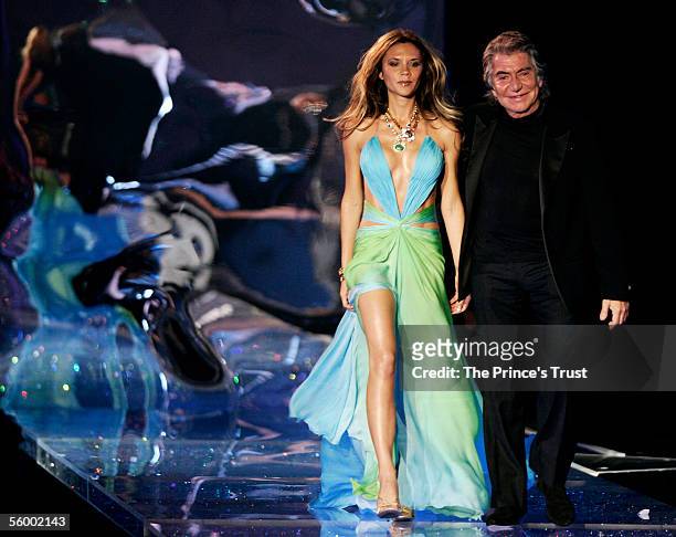 Victoria Beckham and designer Roberto Cavalli arrive on stage at the Swarovski Fashion Rocks for The Prince's Trust event at the Grimaldi Forum...
