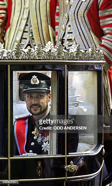 Norway's Crown Prince Haakon sits in a carriage accompanied by Crown Princess Mette-Marit as they ride down The Mall on route to Buckingham Palace in...