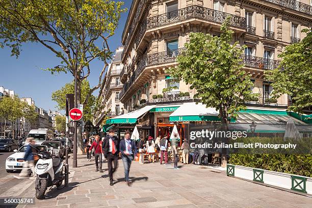 a busy boulevard saint germain in paris. - street paris stock pictures, royalty-free photos & images