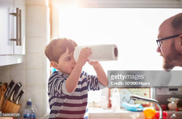 father and son playing the kitchen - kitchen paper stock-fotos und bilder