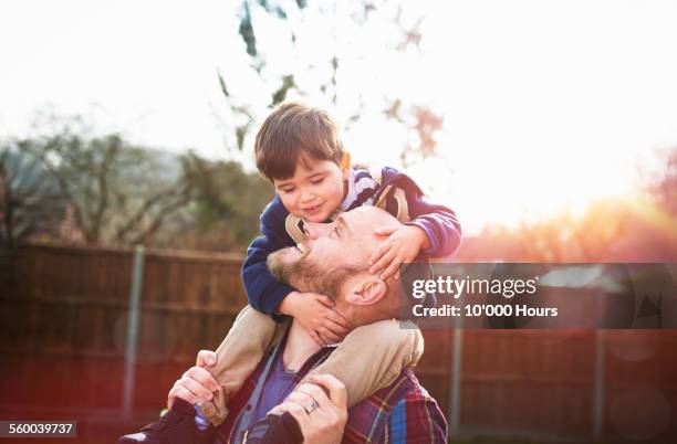 son sitting on father's shoulders - day 3 bildbanksfoton och bilder