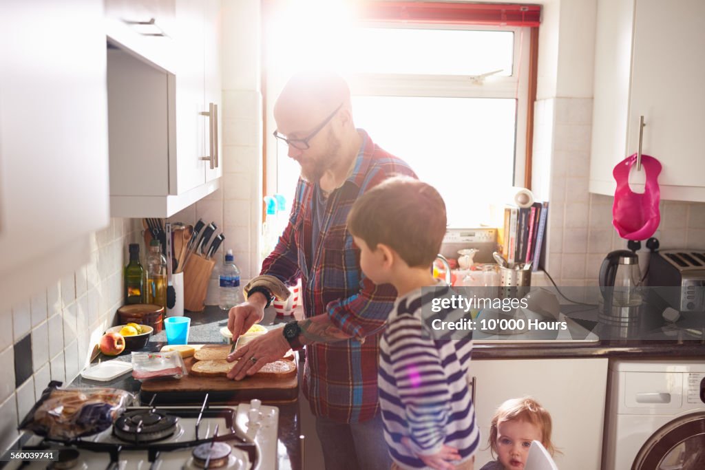Dad making lunch for his children