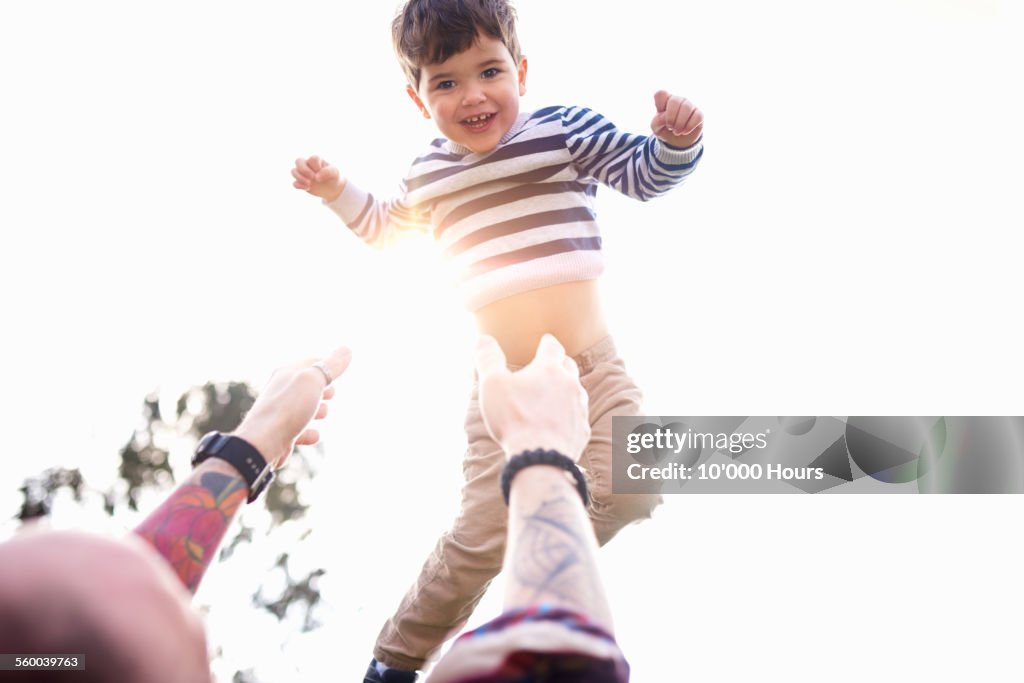 Father throwing his son in the air