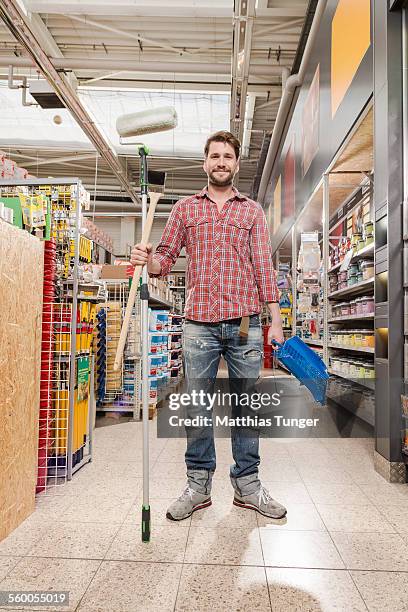 young man with painting equipment - baumarkt stock pictures, royalty-free photos & images