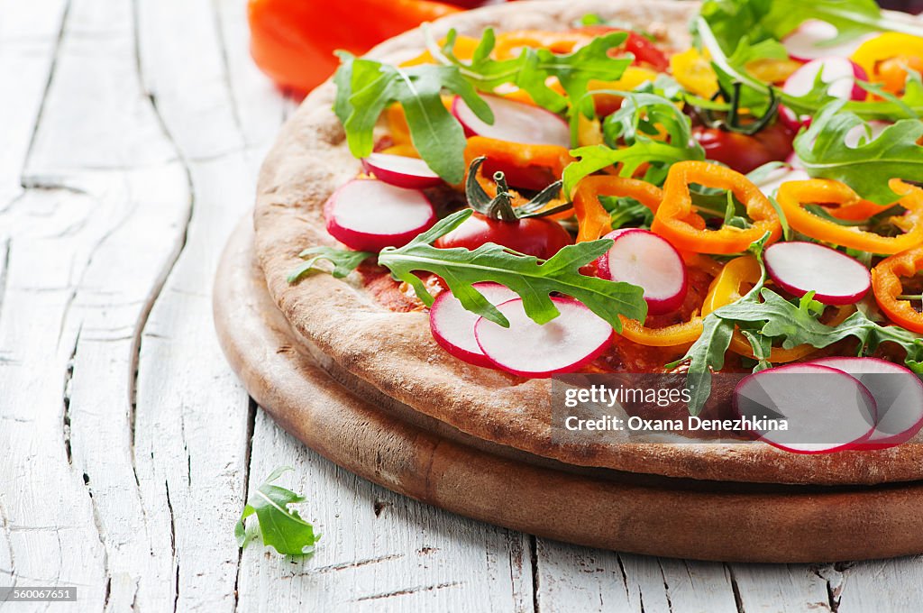 Vegan pizza with tomato, radish and paprika