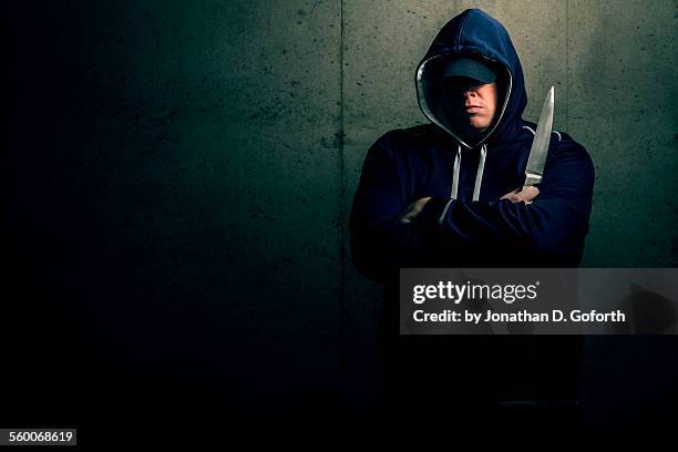lurking in the shadows - kapuze stock-fotos und bilder