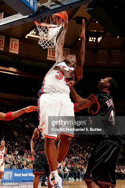 Eddy Curry of the New York Knicks dunks against Steven Hunter of the Philadelphia 76ers during a preseason game October 18, 2005 at Madison Square...