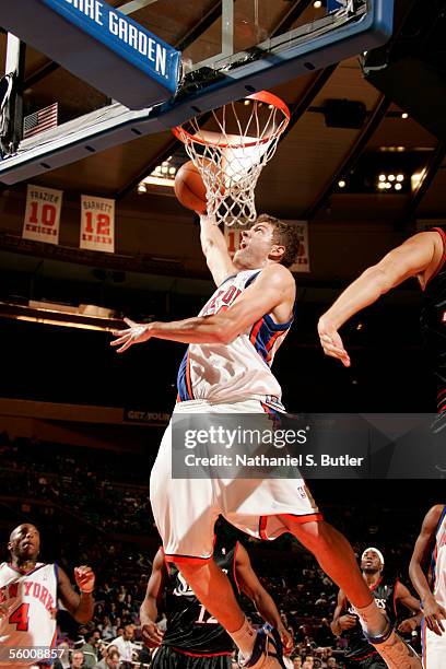 David Lee of the New York Knicks attempts a shot under the basket against the Philadelphia 76ers during a preseason game October 18, 2005 at Madison...