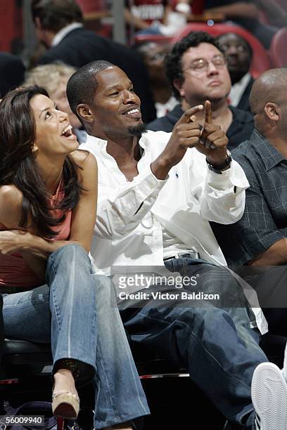 Actors Eva Longoria and Jamie Foxx watch during the Hurricane Katrina Relief Benefit Game between the San Antonio Spurs and the Miami Heat at...