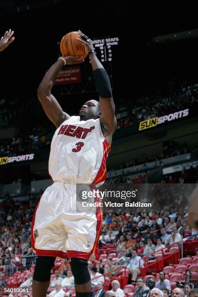 Dwyane Wade of the Miami Heat takes a jump shot during the Hurricane Katrina Relief Benefit Game with the San Antonio Spurs at American Airlines...