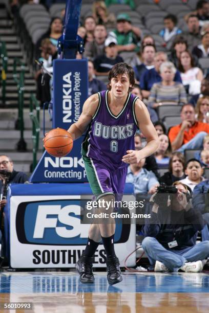 Andrew Bogut of the Milwaukee Bucks drives the ball down the court against the Dallas Mavericks on October 25, 2005 at American Airlines Center in...