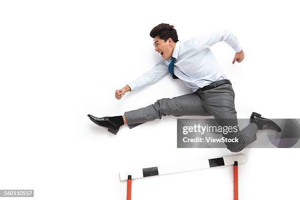 a young business man hurdles - jumping hurdles business stock pictures, royalty-free photos & images