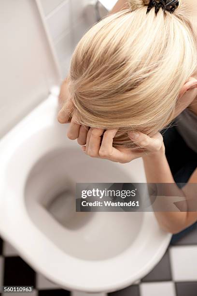 despaired anorexic young woman at the toilet - vomiting stock pictures, royalty-free photos & images