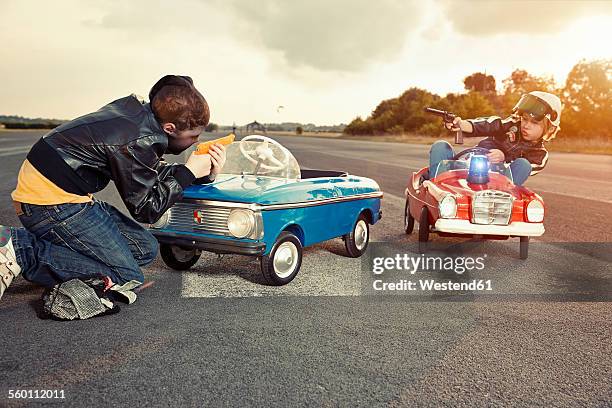two boys playing cops and robbers - stocking mask stock pictures, royalty-free photos & images