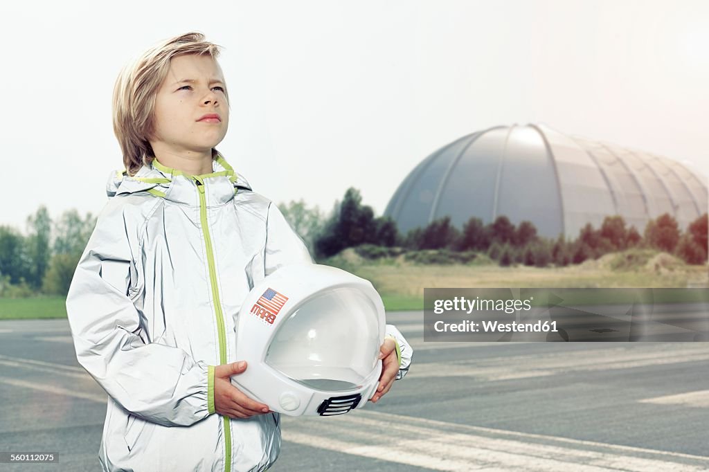 Boy dressed up as spaceman looking up