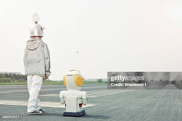 boy dressed up as spaceman with robot - child standing stock pictures, royalty-free photos & images