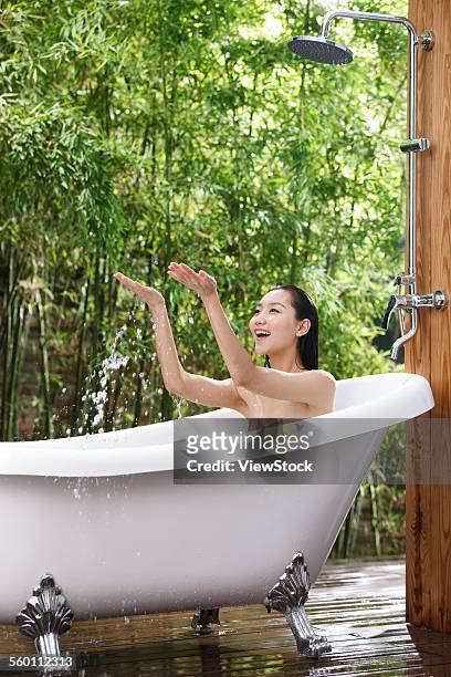 a young woman to play in the bathtub - sunken bath stock pictures, royalty-free photos & images