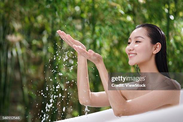 a young woman in the outdoor bathing - sunken bath stock pictures, royalty-free photos & images