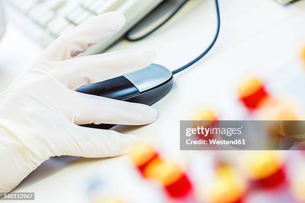blood samples and hand with protective glove using computer mouse - serology stock pictures, royalty-free photos & images