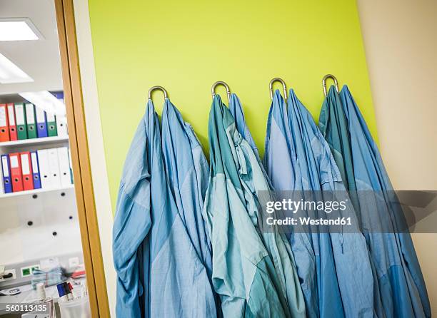 lab coats hanging on coat hook - white lab coat hanging stock pictures, royalty-free photos & images