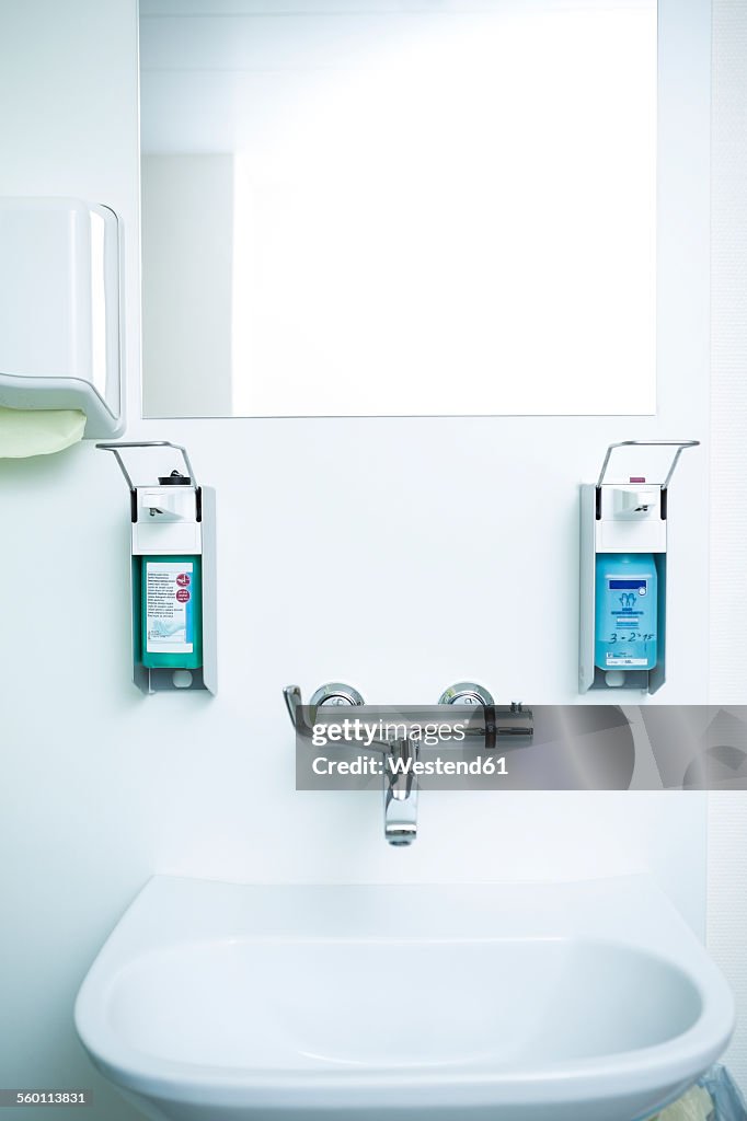 Disinfecting and soap dispenser at sink