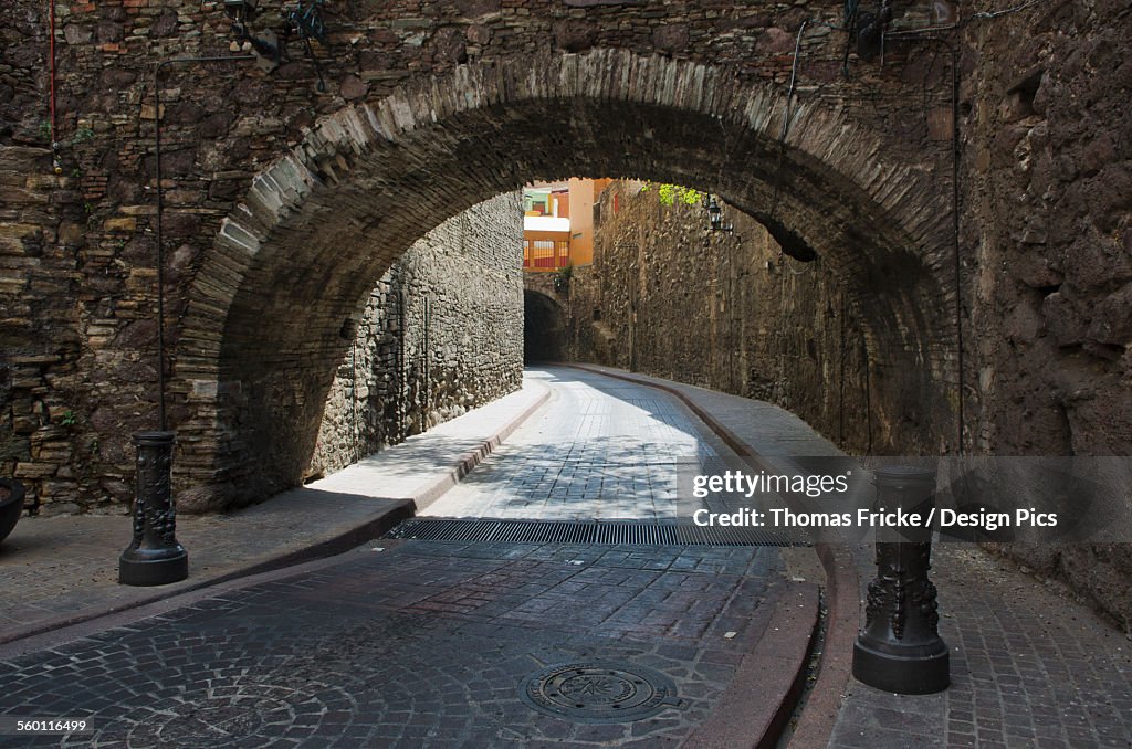 Archway over cobblestone streets