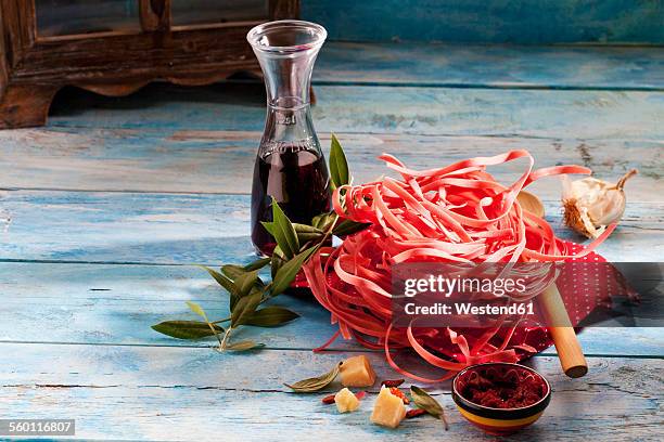 barolo tagliatelle, parmesan, garlic, tomato pesto and carafe of red wine - red salvia stock pictures, royalty-free photos & images