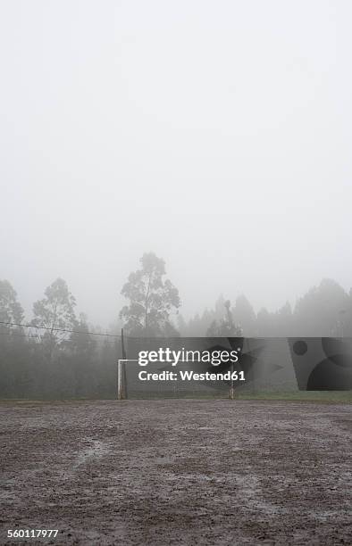 spain, galicia, valdovino, muddy soccer field on a rainy and foggy day - muddy football pitch stock pictures, royalty-free photos & images