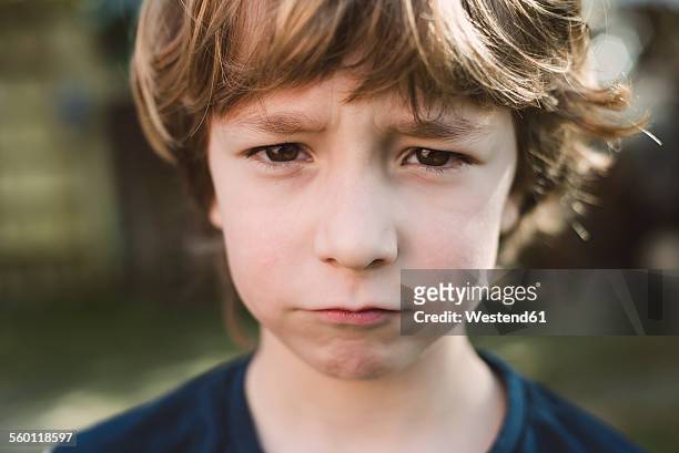 portrait of little boy pouting mouth - angry faces photos et images de collection