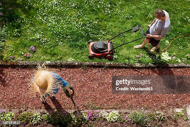 couple gardening in spring - lawnmowing stock pictures, royalty-free photos & images