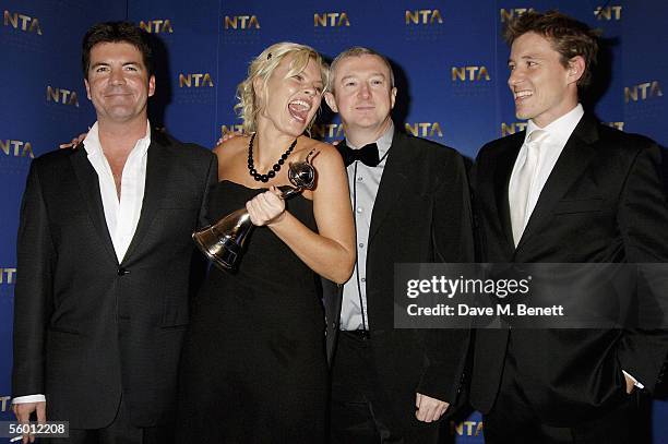 Producer Simon Cowell, presenter Kate Thornton, producer Louis Walsh and Ben Shepherd pose in the awards room with the Most Popular Entertainment...