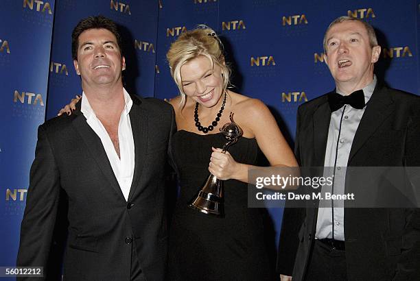 Producer Simon Cowell, presenter Kate Thornton and producer Louis Walsh pose in the awards room with the Most Popular Entertainment Programme Award...