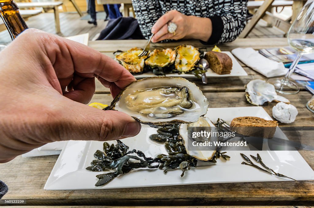 Eating Zeeland oysters in a restaurant