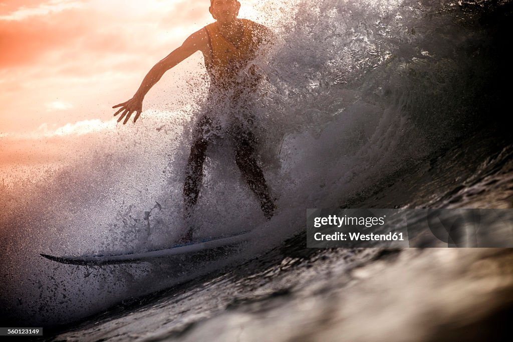Indonesia, Lombok Island, surfing man at backlight