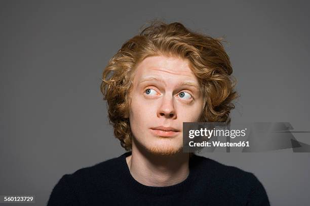 portrait of sceptical young man - raised eyebrows stock-fotos und bilder