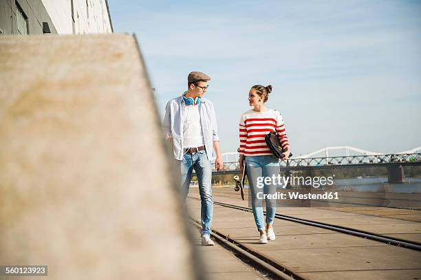 young man and woman walking at track by the riverside - mannheim stock-fotos und bilder
