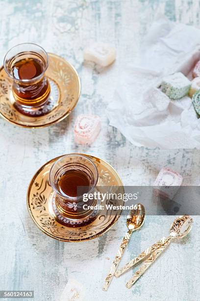 two glasses of turkish black tea and sweets - turkish delight stock pictures, royalty-free photos & images