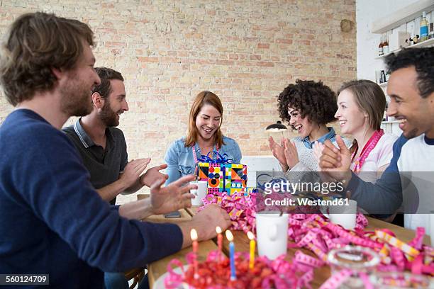 group of friends celebrating birthday - gift lounge stock-fotos und bilder