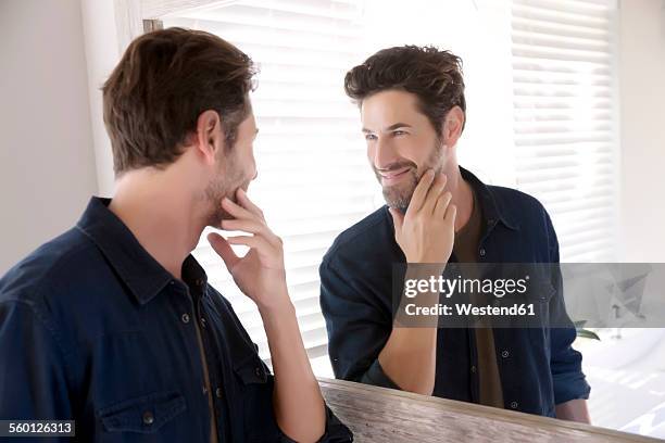 man watching himself at bathroom mirror - double facepalm stock pictures, royalty-free photos & images