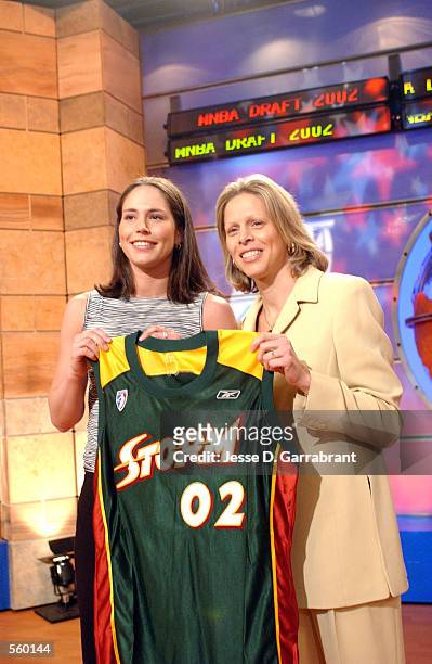 Sue Bird, the pick of the WNBA Draft 2002, is selected by the Seattle Storm and poses with commissioner Val Ackerman during the WNBA Draft in...