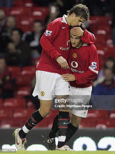 Gerard Pique of Manchester United congratulates Giuseppe Rossi on scoring the third goal during the Carling Cup third round match between Manchester...