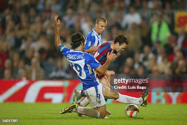 Andres Iniesta of Barcelona and Fernando Sanz of Malaga during the match between FC Barcelona and Malaga of the Spanish Primera Liga at the Camp Nou...