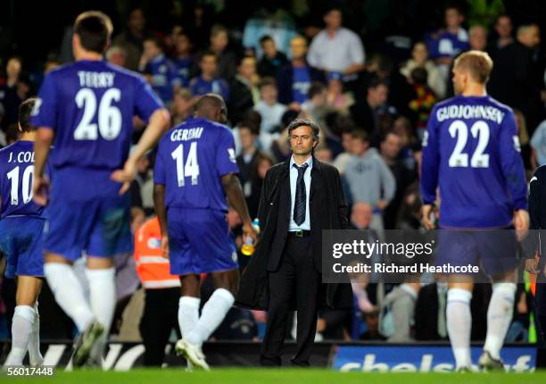 Jose Mourinho the Chelsea manager watches his dejected players walk off after losing the penalty shootout during the Carling Cup Third Round match...