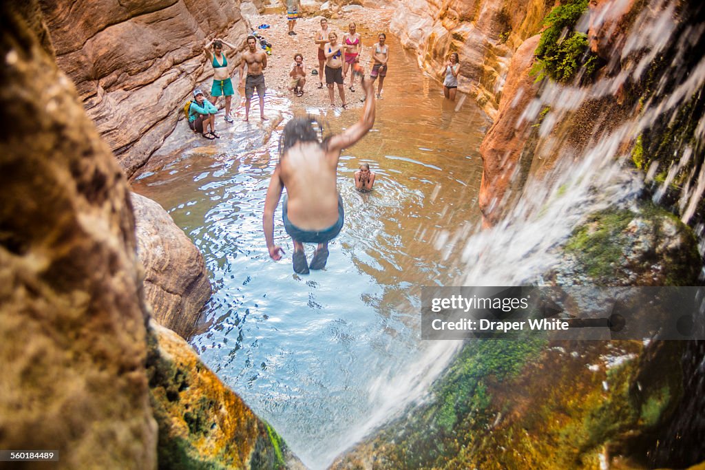 Man Jumping off Waterfall