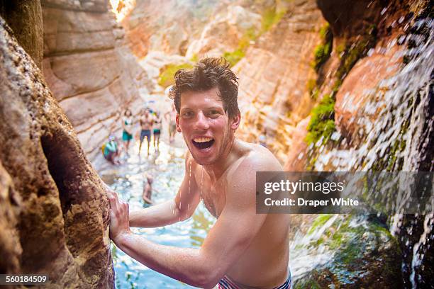 man smiles in waterfall. - grand canyon waterfall stock pictures, royalty-free photos & images