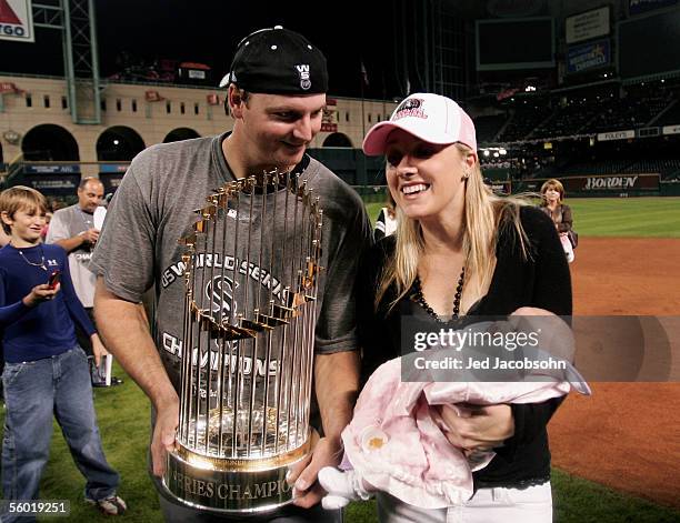 Pierzynski of the Chicago White Sox celebrates with his wife and baby while he holds the Championship trophy after winning Game Four of the 2005...