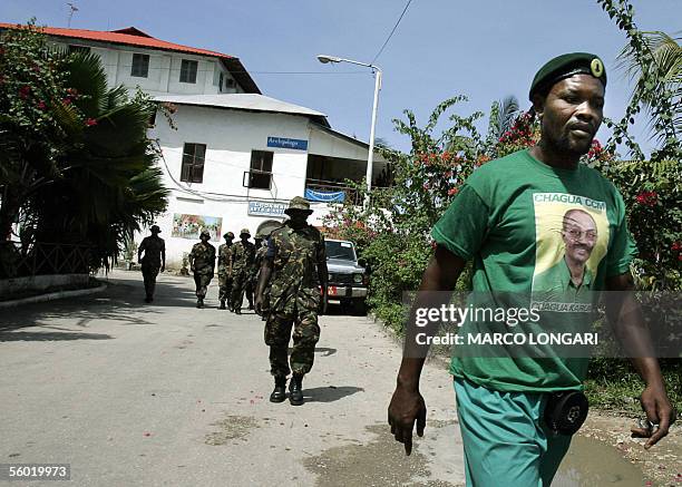 Tanzanian soldiers walk on a waterfront following a ruling Chama Cha Mapinduzi supporter in Stone Town, Zanzibar, 27 October 2005. A decade of...