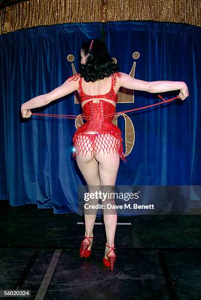 Burlesque artist Dita Von Teese performs on stage at Cafe De Paris' 80th birthday on October 27, 2005 in London, England.