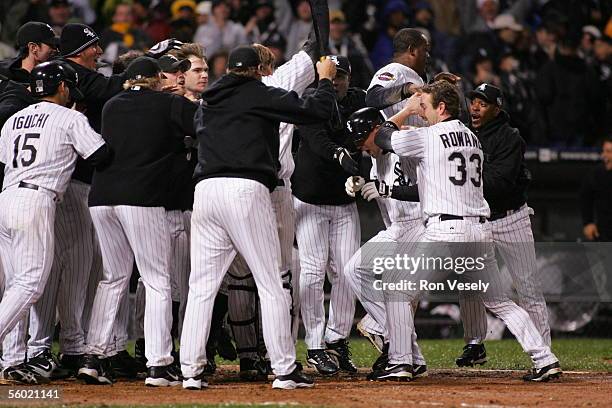 Scott Podsednik of the Chicago White Sox is mobbed by teammate Aaron Rowand and the rest of the Chicago White Sox after hitting a game winning, walk...