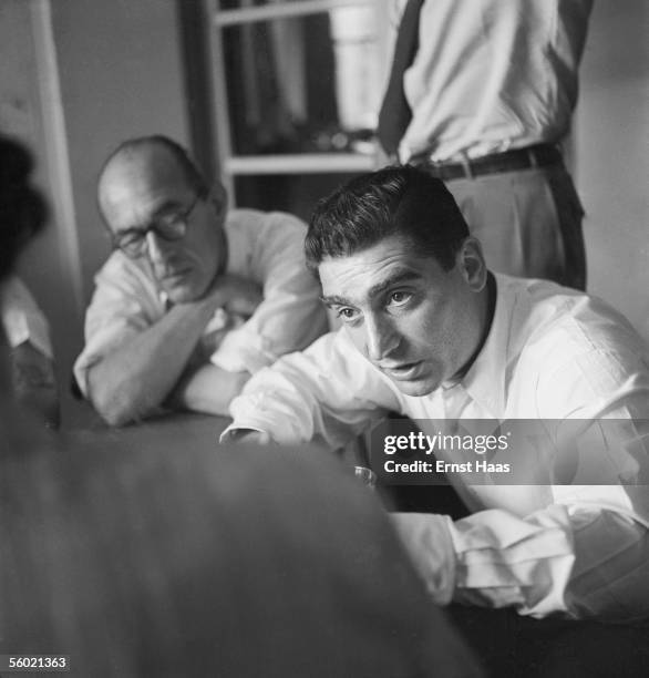 Hungarian-born photojournalist Robert Capa chairs a meeting of the Magnum photographic co-operative, Paris, circa 1947.